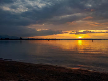 Scenic view of lake chiemsee against sky during sunset 