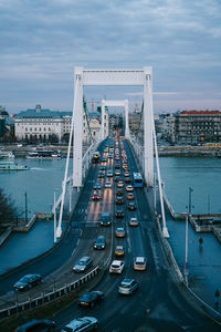 High angle view of bridge in city against cloudy sky