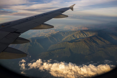 Aerial view of aircraft wing over landscape