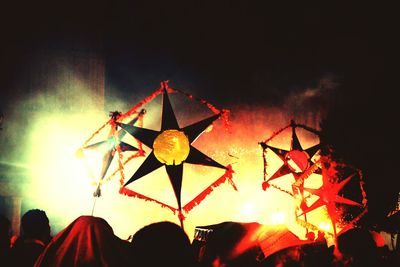 Low angle view of firework display at night