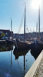 Sailboats moored in harbor