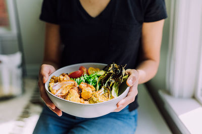 Midsection of woman holding food