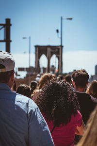 Rear view of people on stage in city against sky