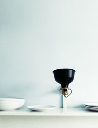 Close-up of wineglass on table against white background