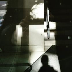 Shadow of person on tiled floor