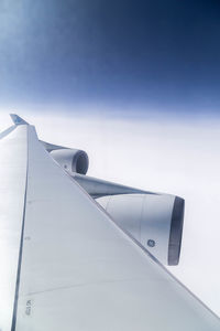 Low angle view of airplane flying against sky