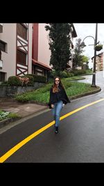 Portrait of young woman on road