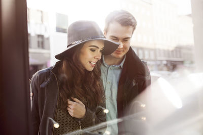 Young couple looking in shop window