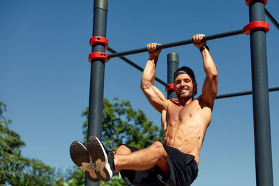 Low angle view of man exercising on field