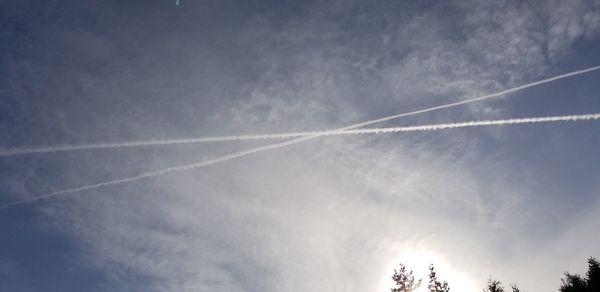 Low angle view of vapor trails in sky