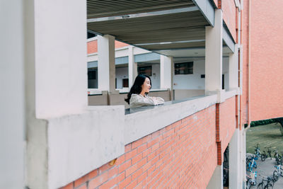 Young woman standing in corridor of building