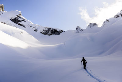 Woman backcountry skiing in skypilot bowl wondering where to go