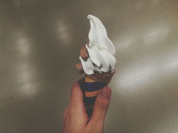 Close-up of hand holding ice cream cone