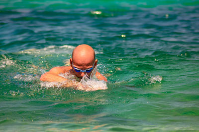 High angle view of man swimming in sea