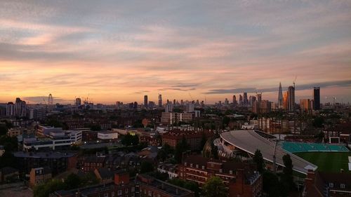 View of cityscape against cloudy sky