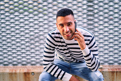 Portrait of young man sitting outdoors