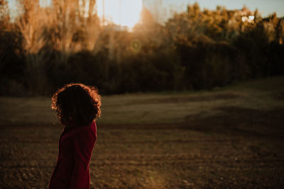 Rear view of girl standing on field