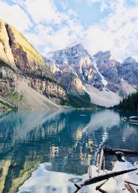 Scenic view of lake by snowcapped mountains against sky