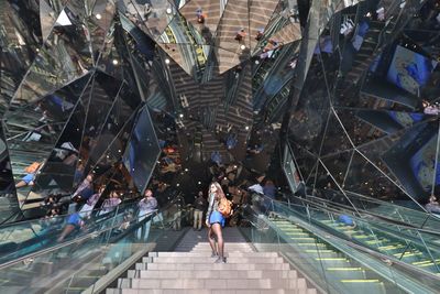 High angle view of woman walking on staircase