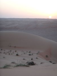 Scenic view of desert against sky during sunset