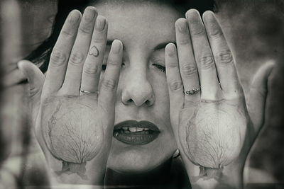 Close-up portrait of woman covering face