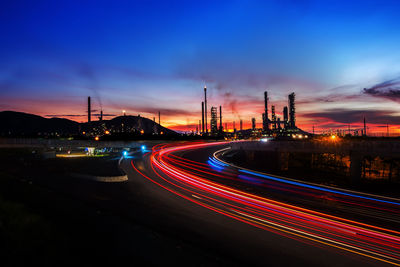 Light trails on road in city at night