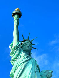 Low angle view of statue against clear blue sky