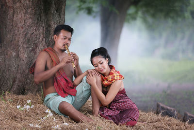 Young couple sitting on land