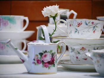 Close-up of white roses in vase on table