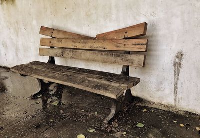 Empty bench against wall