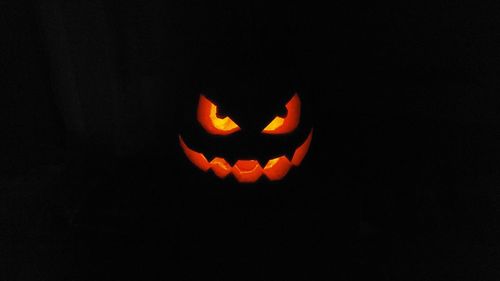 Close-up of illuminated pumpkin against black background