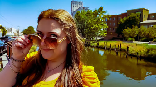 Portrait of woman drinking water in swimming pool