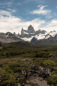 Scenic view of mountains against cloudy sky