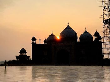 Built structure against sky at sunset