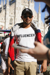 Portrait of man wearing sunglasses standing on street