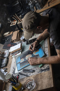 High angle view of man working on table