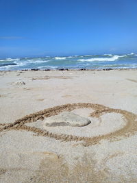 Hear shape drawn at sandy beach