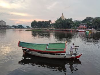 Boat moored in river against sky