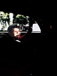 Man looking through car window