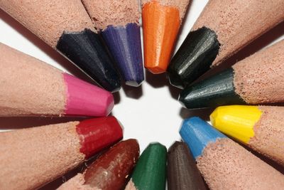 Close-up of multi colored pencils on white background