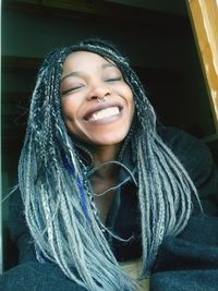 Close-up of smiling young woman with dyed hair