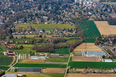 High angle view of crowd on field by buildings