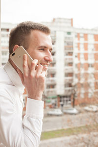 Side view of man talking on phone