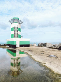 Lifeguard hut on beach against sky