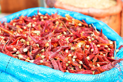 Close-up of red chili peppers in container