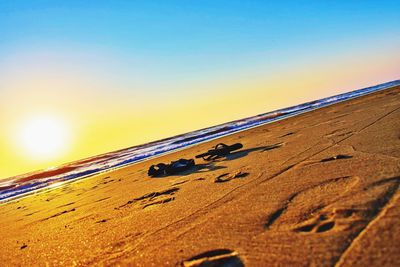 Text on sand at beach against clear sky