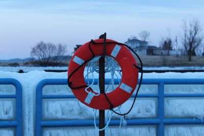 Life belt against sky during winter