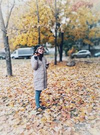 Woman standing on leaves during autumn