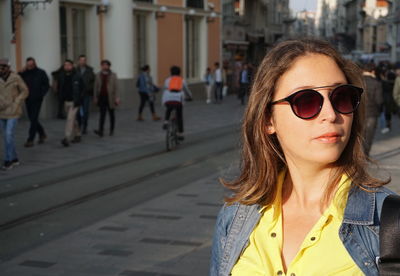 Woman wearing sunglasses in city