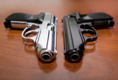 High angle view of handguns on wooden table